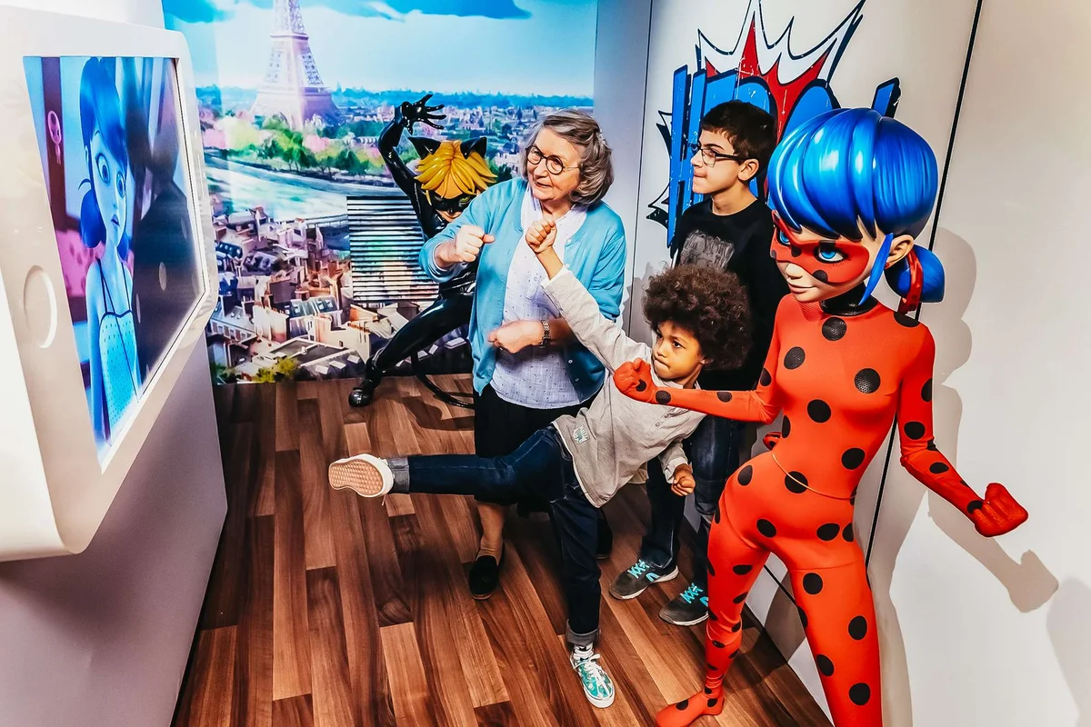 Visitors posing with wax figures at the Grévin wax museum, one of the most fun museums in Paris for families