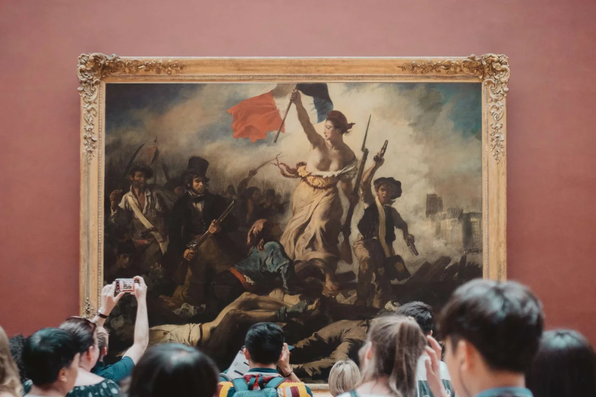 Delacroix's Liberty Leading the People on the wall of the Louvre, the most famous of the museums in Paris
