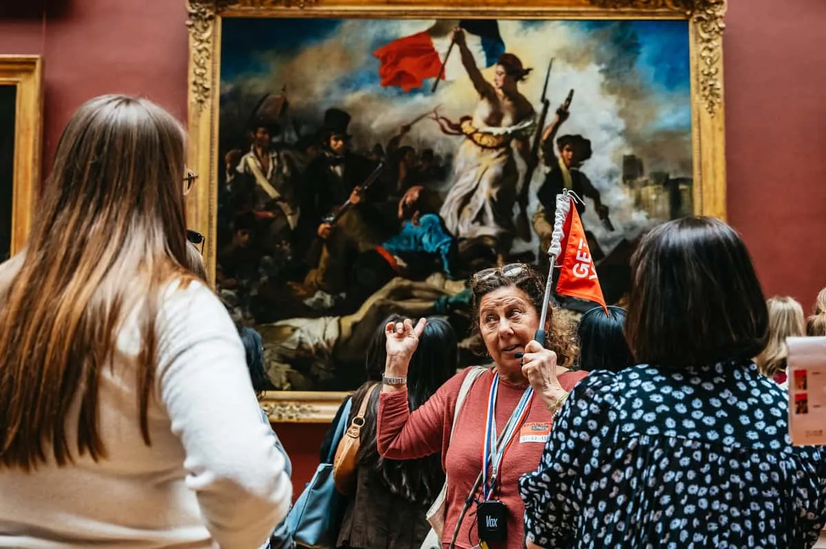 Crowd viewing the Mona Lisa inside the Louvre, one of the top museums in Paris, France